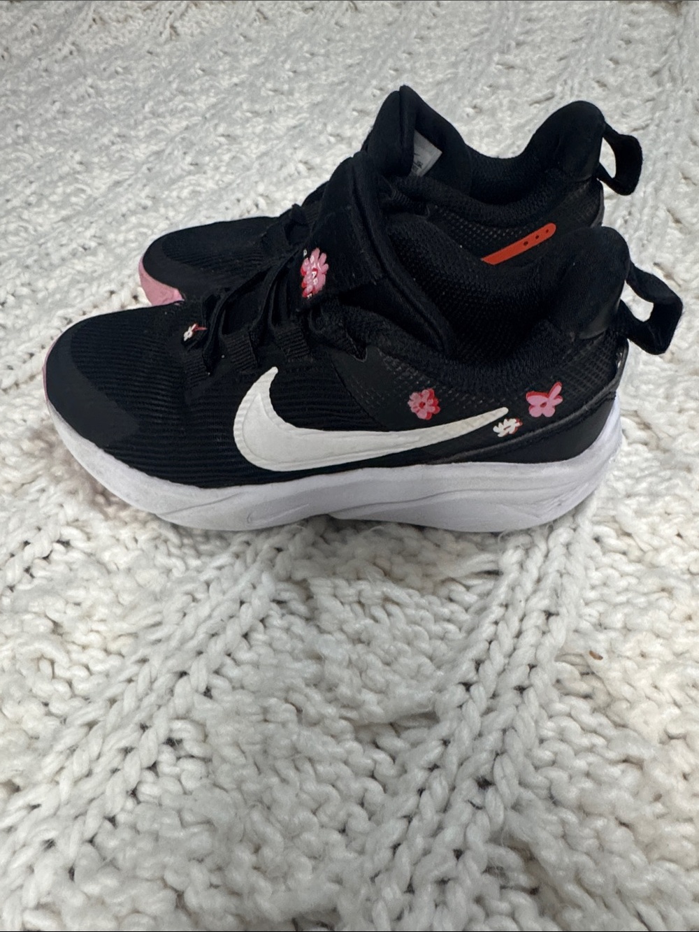 Nike Kids Black Sneakers with White Swoosh and Pink Floral Accents